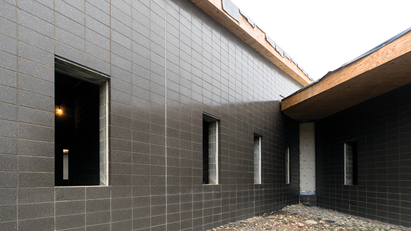 The exterior skin of the building features accent areas made up of ground face concrete masonry units in a striking black finish. Image courtesy of SEME Resources