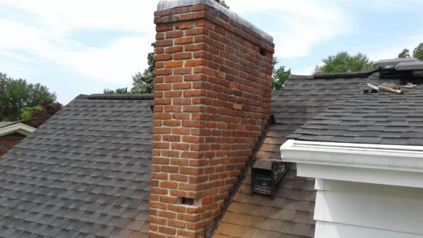 Shown is a spalled brick in a chimney in need of repair.